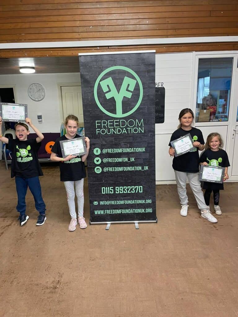 learners posing in front of the banner for the programme