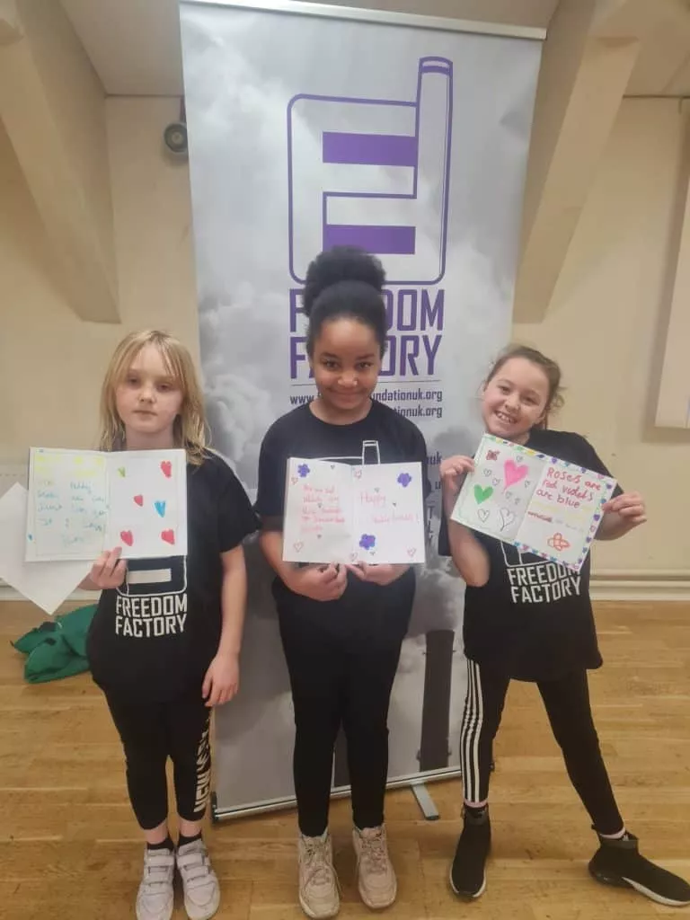 a group of children showing thier work